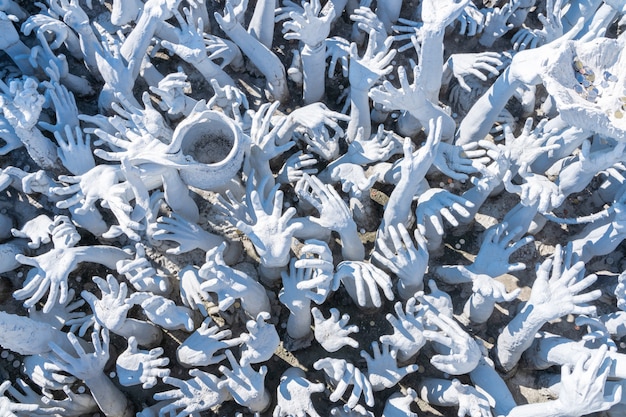 Detail of the stone hands of the white temple of Chiang Rai in northern Thailand