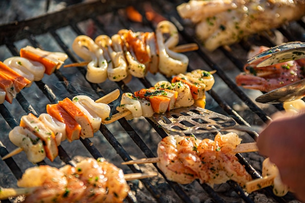 Detail of tasty Fish skewers on the grill with smoke