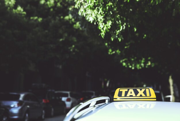 Photo detail of the taxi car on the street with copy space and blurred background