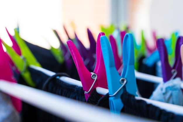 Detail of two clothespins holding clothes laundry and housework concept