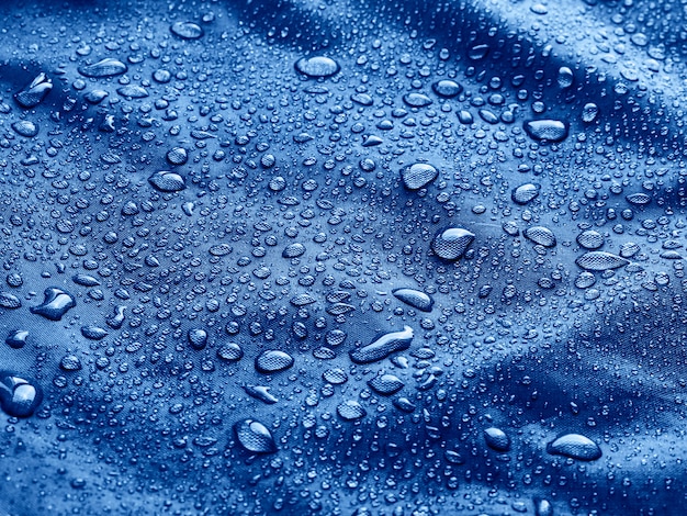 Detailed drops of water on a blue cloth