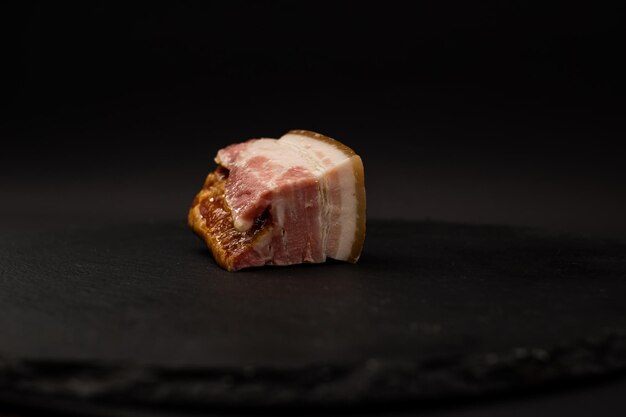 A detailed shot of bacon on a black background