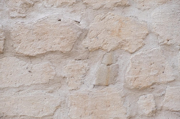 Detailed textured background of sandstone old wall with blocks light yellow colored