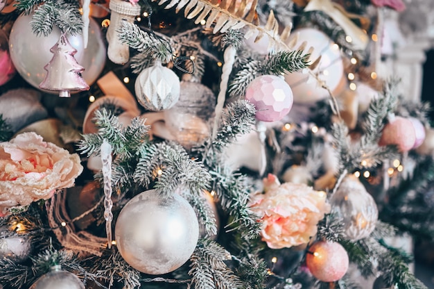 Details of a Christmas decorated tree in soft pink colors.