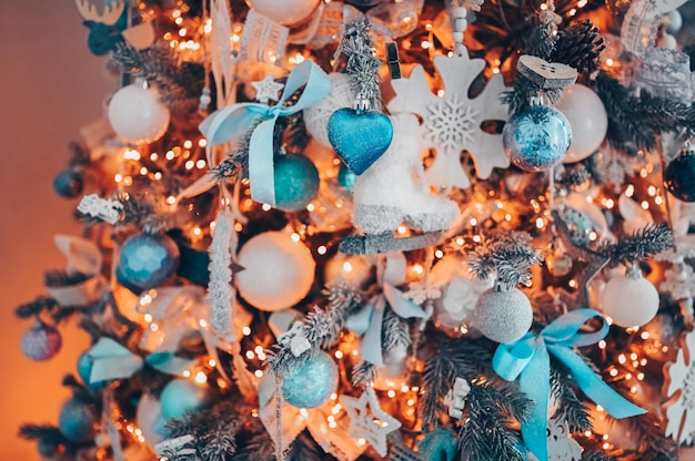 Details of a Christmas decorated tree in soft pink and turquoise colors