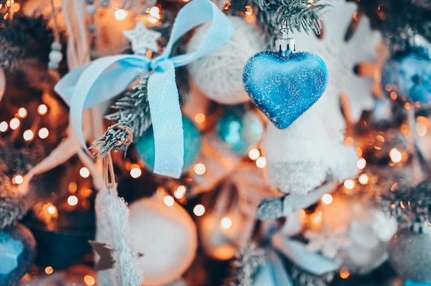 Details of a Christmas decorated tree in soft pink and turquoise colors