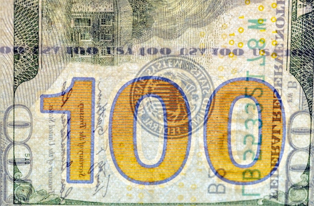 details of a genuine American banknote with a face value of 100 part of a hundreddollar bill of the United States of America closeup