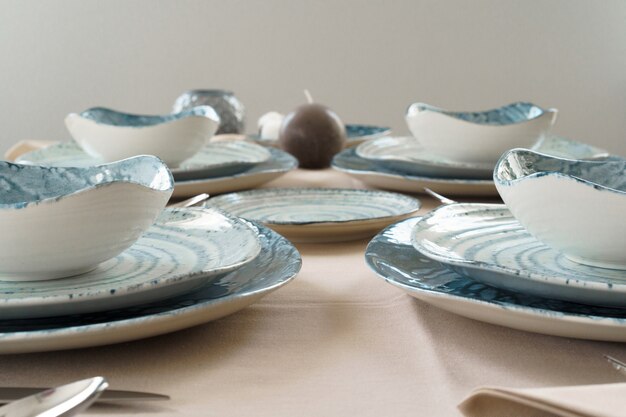 Details of a stylish table setting with textured ceramic dishes