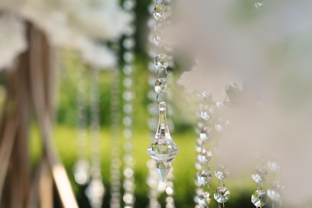 Details of the wedding ceremony made of fresh flowers sparkling beads