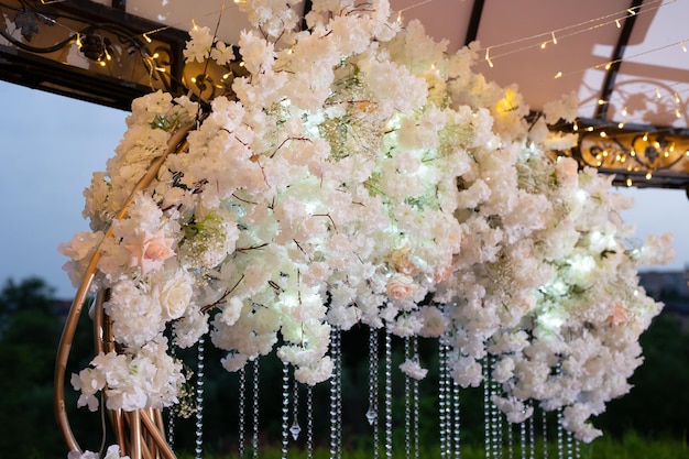 Details of the wedding ceremony made of fresh flowers sparkling beads