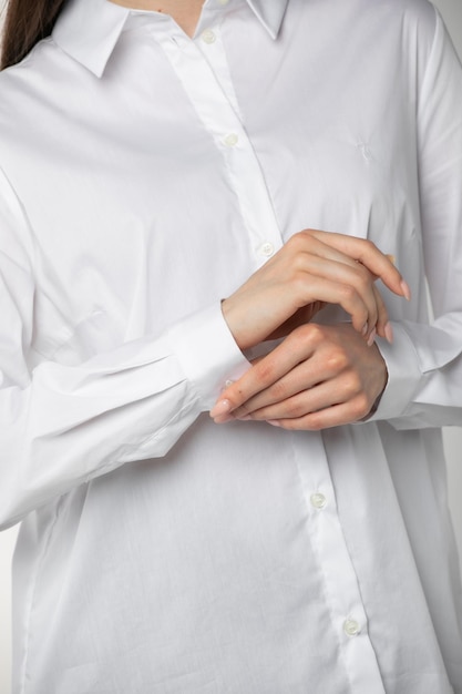 Details of woman clothing closeup of white shirt wiht sleeves on female model