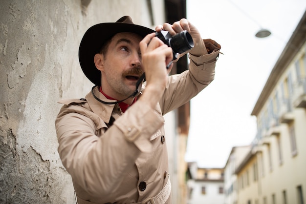 Detective taking pics in a slum with his vintage camera