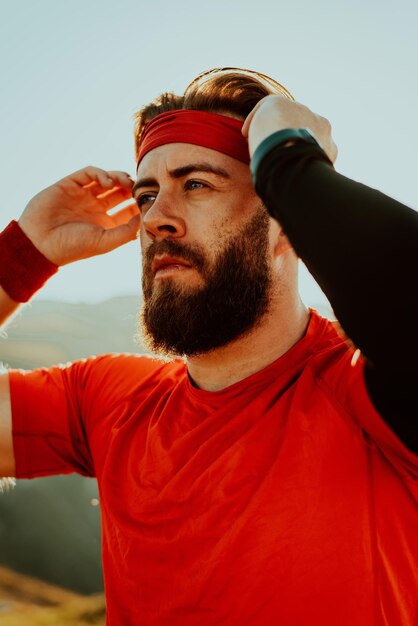 A determined athlete preparing for the start of training on the top of the mountain at sunrise.