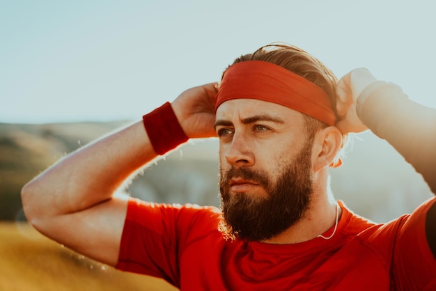 A determined athlete preparing for the start of training on the top of the mountain at sunrise