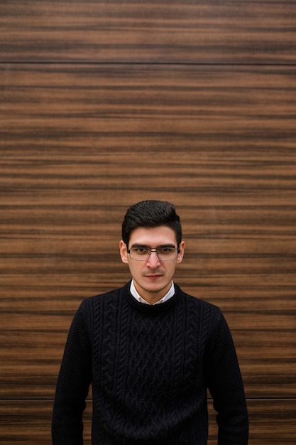 Determined concentrated serious business man. modern smart professional worker. wood texture wall background. outdoors street. copyspace concept