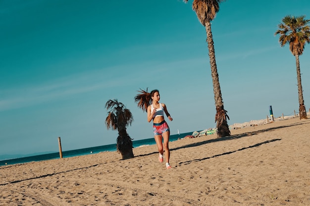 Determined to win. Full length of beautiful young woman in sports clothing jogging while exercising outdoors