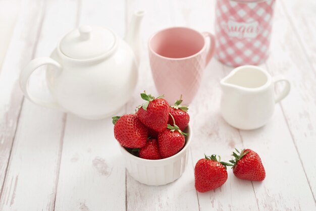 Detox concept. Tasty fruits and berries. Healthly food. Veganism, vegetarianism, raw food diet. Strawberries and tea set. Summer fresh fruits. Copy space.Vitamins in food. Healthy breakfast.