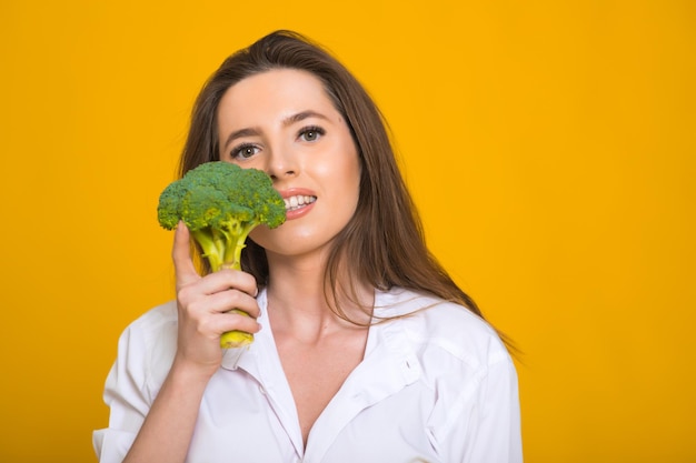 Photo detox diet concept woman holds green broccoli sprouts for healthy nutrition