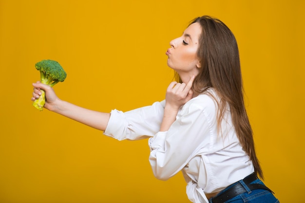 Photo detox diet concept woman holds green broccoli sprouts for healthy nutrition