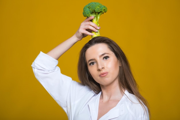 Photo detox diet concept woman holds green broccoli sprouts for healthy nutrition