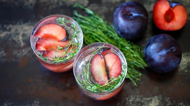 Detox drink with thyme and plum Refreshing summer cocktail