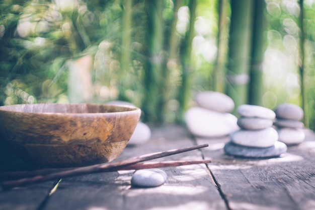 Detox food with empty wooden bowl and wooden chopsticks 