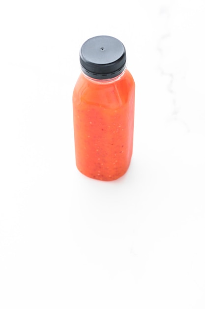 Detox red fruit smoothie juice in a bottle diet catering delivery Isolated on white background