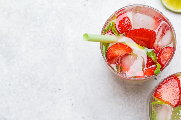 Detox sassy water with strawberries and lime in glasses, top view. Healthy eating concept.