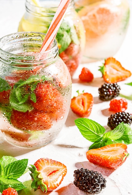 Detox smoothies of fresh fruits and vegetables in glass jars with tubes