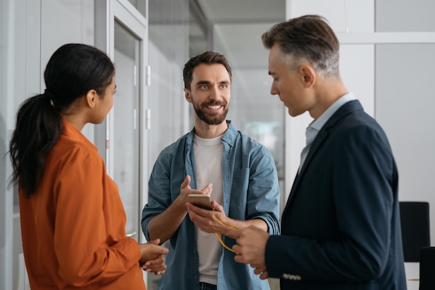 Developer using mobile phone communicating with colleagues