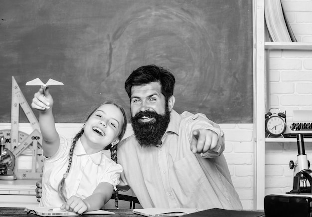 Developing caring learners who are actively growing and achieving School learners leisure Creating a community of learners Teacher and schoolgirl Man bearded pedagogue and pupil having fun