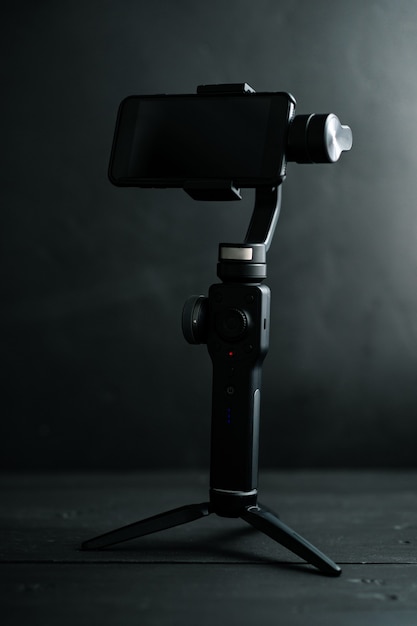 A device for image stabilization when taking photos and videos on a smartphone on a black background