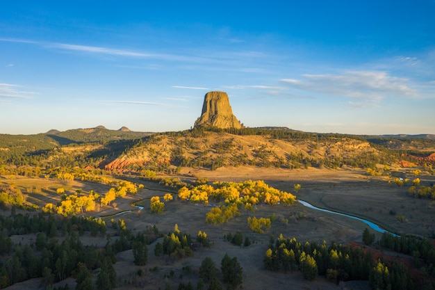 Devils Tower Butte and Belle Fourche River in Sunny Autumn Morning. Crook County. Wyoming, USA. Aerial View