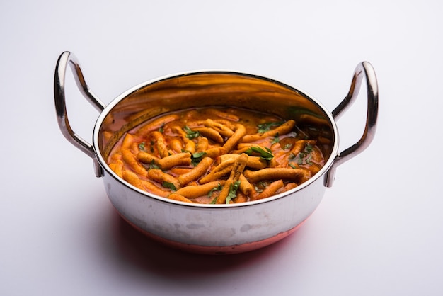 Dhaba style Sev bhaji, sabzi, curry made in tomato curry with gathiya or ganthia shev, served in a bowl or karahi, selective focus