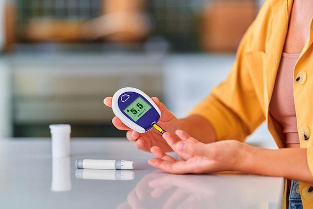 Diabetic patient checks blood glucose level at home