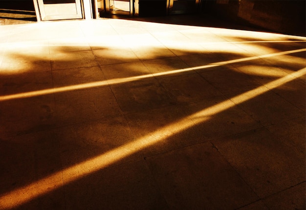 Diagonal light rays on city street asphalt backdrop