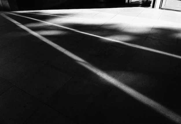 Diagonal light rays on city street asphalt