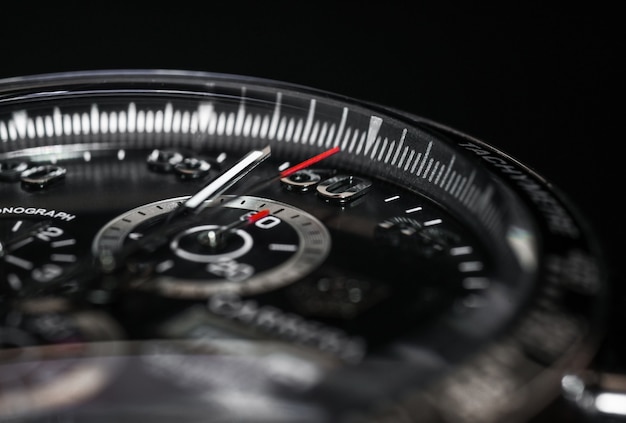 Dial Luxury quartz watch chronograph on a black background, close-up.