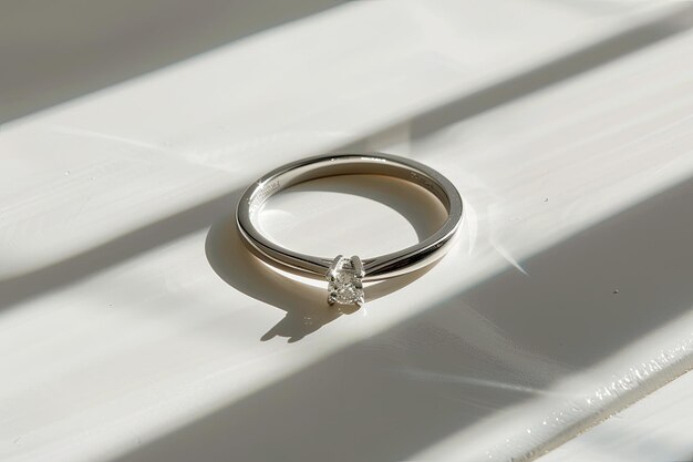 Photo diamond studded silver ring on white background with shadows artistic still life photo