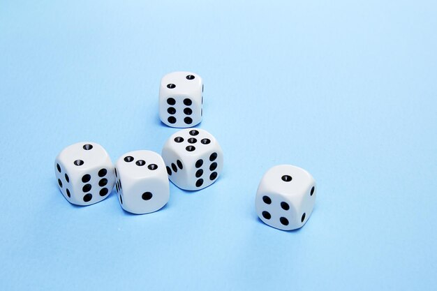 Dice for the game are scattered on a blue field