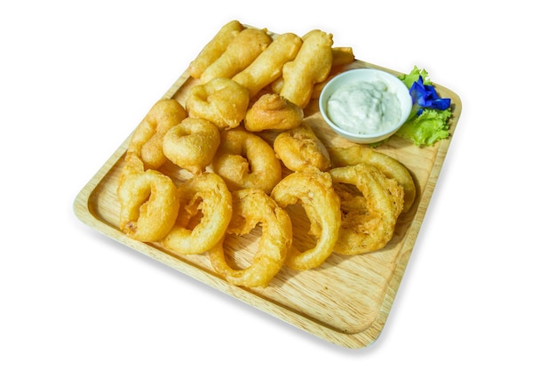 Die cut of Onion rings with dip Deepfried flour with sour cream sauce on wooden plate on white isolated