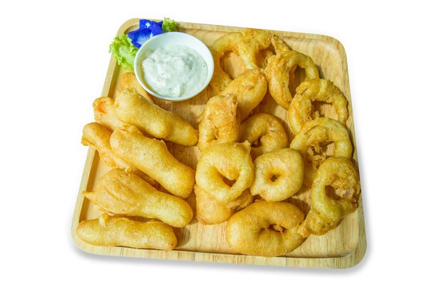 Die cut of Onion rings with dip Deepfried flour with sour cream sauce on wooden plate on white isolated