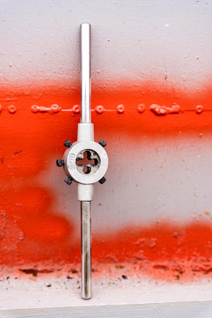 A die for threading on a shelf in the workshop