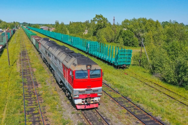 Diesel locomotive train and carriage hopper at a reloading freight railway station