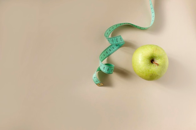 Diet concept Apple with measuring tape