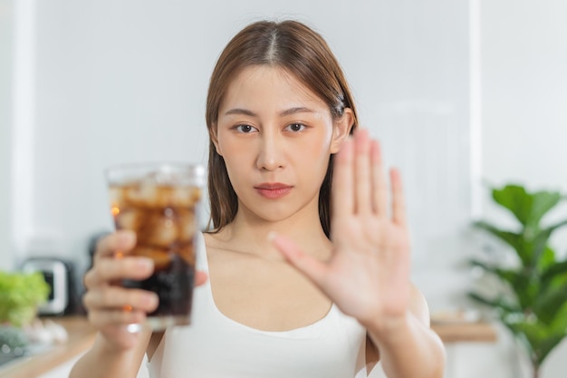 Diet Dieting asian young woman hand in push out deny sweet sparkling water xAsuffering from toothache sensitivity inflammation when drink cold Sensitive teeth health weight loss people