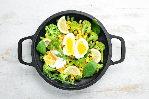 Diet food Boiled vegetables and boiled egg in a frying pan Rustic style Top view Free space for your text