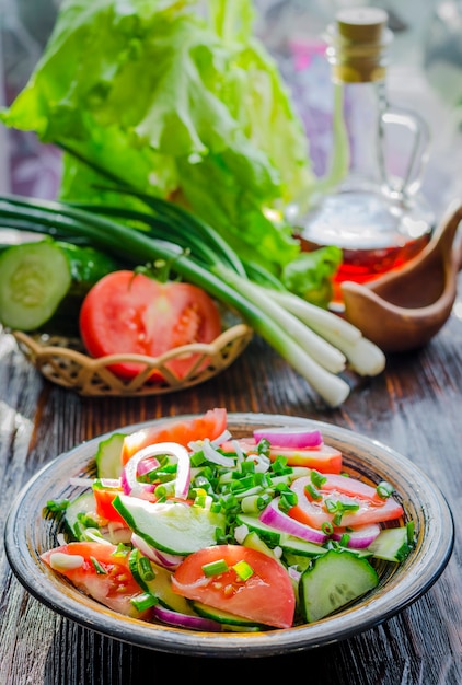 Diet salad of fresh cucumbers, tomatoes and young onions