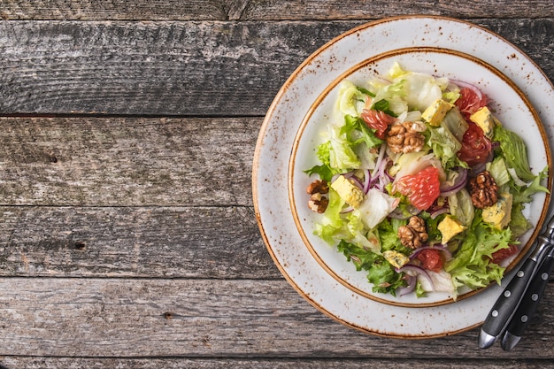 Diet salad  garpefruit, cheese, lettuce and walnut on a plate. Diet and healthy salad   . Top view