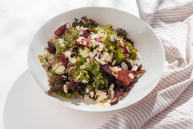 Diet salad with magre duck breast fresh herbs vegetables sauce on a light wood background